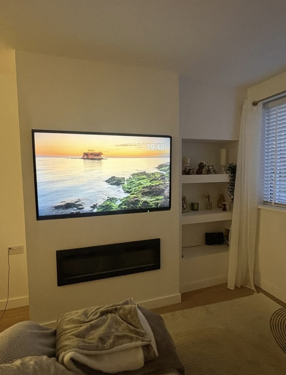 Finished media wall with mounted television and built-in shelves