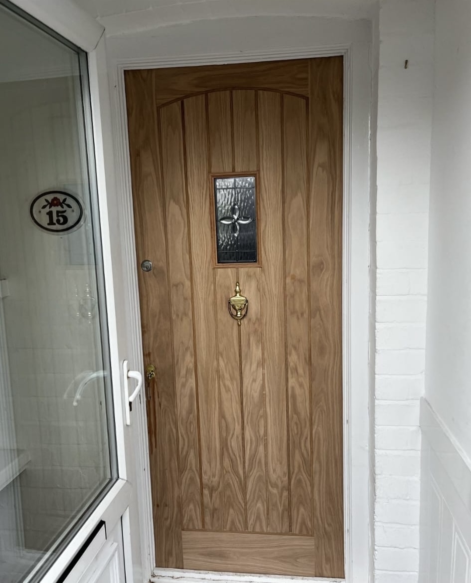 New hardwood front door fitted in a porch entrance