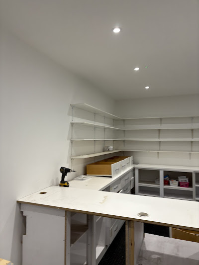 Kitchen and cabinetry installation with shelving and work surfaces